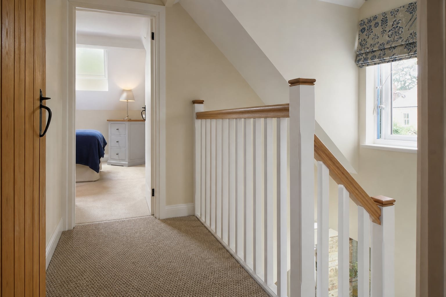 Assessor reviewing a holiday cottage stair and landing in soft daylight